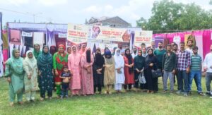 Group photo of artisans and exhibitors at the Exhibition-Cum-Sale of Handicraft Products under the NHDP Scheme, proudly displaying handcrafted creations